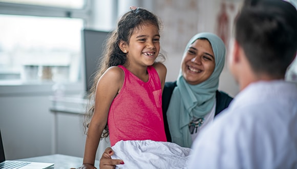 Mother taking her daughter to the doctor for a back to school check up