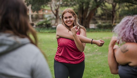 Woman doing arm exercises in the park