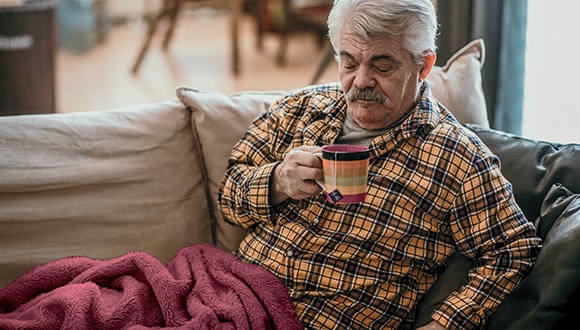 Man sitting on the lounge with shingles