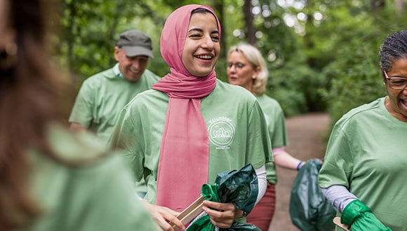 Group of people looking happy while doing volunteer work