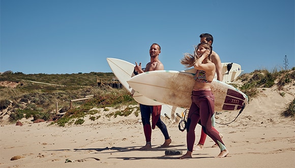 Friends on the beach after surfing 