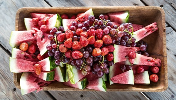 An assortment of fruit including: watermelon, strawberries and grapes