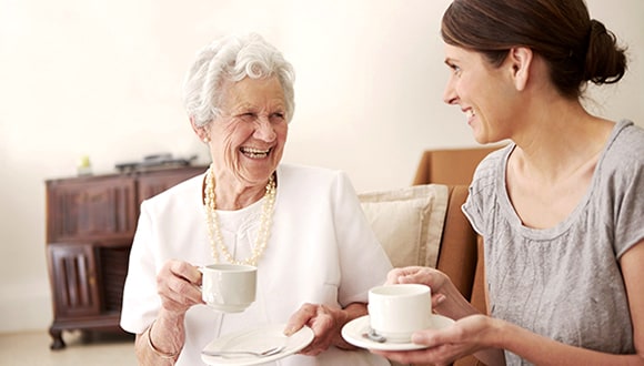 Mother and daughter drinking tea together