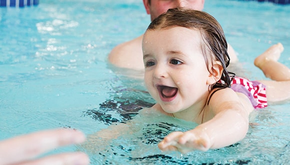 Little girl learning how to swim