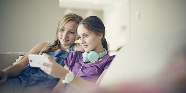 two girls looking at a mobile phone