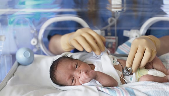 Newborn child in incubator