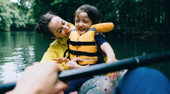 Family kayaking on a river