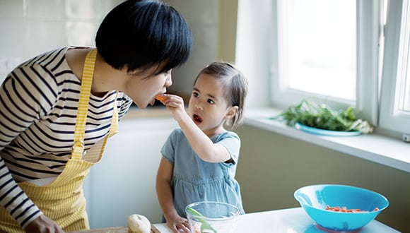 A photo of a mother and daughter in the kitchen