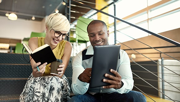 Two colleagues working together in a workplace environment