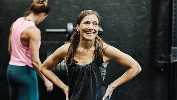 Woman in perimenopause exercising in a gym